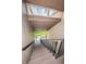 Indoor staircase with metal railings and window overlooking the grounds at 19725 Gulf Blvd # 46, Indian Shores, FL 33785