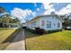 Community clubhouse with orange decor and landscaping at 200 Glennes Ln # 206, Dunedin, FL 34698