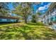 Residential community with mature trees and green lawns at 200 Glennes Ln # 206, Dunedin, FL 34698