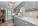 Modern kitchen with gray cabinets, quartz countertops, and stainless steel appliances at 200 Glennes Ln # 206, Dunedin, FL 34698