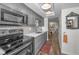 Modern kitchen with gray cabinets, quartz countertops, and stainless steel appliances at 200 Glennes Ln # 206, Dunedin, FL 34698