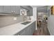 Modern kitchen with gray cabinets, quartz countertops, and stainless steel appliances at 200 Glennes Ln # 206, Dunedin, FL 34698