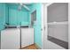 Shared laundry room with coin-operated washer and dryer at 200 Glennes Ln # 206, Dunedin, FL 34698