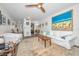 Open living area with hardwood floors, neutral decor, and view into kitchen at 200 Glennes Ln # 206, Dunedin, FL 34698