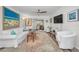 Spacious living area with hardwood floors, comfortable seating, and large artwork at 200 Glennes Ln # 206, Dunedin, FL 34698