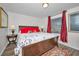 Main bedroom with comfortable king-size bed and red accent pillows at 200 Glennes Ln # 206, Dunedin, FL 34698