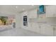 Sleek kitchen featuring modern appliances and double ovens, adjacent to sliding glass doors for outdoor access at 2066 San Marino N Way, Clearwater, FL 33763