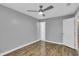 Bedroom with wood floors, neutral paint, ceiling fan and an ensuite bath at 209 Red Cedar Pl # 209, Brandon, FL 33510