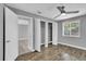 Bright bedroom with wood floors, ceiling fan, window, and walk-in closet at 209 Red Cedar Pl # 209, Brandon, FL 33510