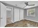 Bedroom with wood floors, ceiling fan, double closets and view to ensuite at 209 Red Cedar Pl # 209, Brandon, FL 33510