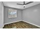 Bedroom featuring a ceiling fan, wood floors, and a window with natural light at 209 Red Cedar Pl # 209, Brandon, FL 33510
