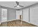 Spacious bedroom with wood flooring, ceiling fan, and double closets at 209 Red Cedar Pl # 209, Brandon, FL 33510