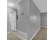 Hallway featuring neutral wall paint, updated flooring, white door, and neutral light fixtures at 209 Red Cedar Pl # 209, Brandon, FL 33510