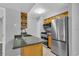 Features an efficient kitchen design with stainless steel appliances, wood cabinets, and granite countertops at 209 Red Cedar Pl # 209, Brandon, FL 33510