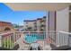 Balcony view overlooking the community pool and partial ocean view at 2900 Gulf Blvd # 212, Belleair Beach, FL 33786