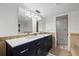 Modern bathroom with double vanity and stylish navy blue cabinets at 2900 Gulf Blvd # 212, Belleair Beach, FL 33786
