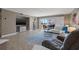 Relaxing living room, featuring a white sectional sofa and sliding glass doors at 2900 Gulf Blvd # 212, Belleair Beach, FL 33786
