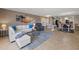 Spacious living area featuring an L-shaped sofa and a large wall art piece at 2900 Gulf Blvd # 212, Belleair Beach, FL 33786