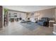 Open living space with white sectional sofa and access to balcony at 2900 Gulf Blvd # 212, Belleair Beach, FL 33786