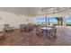Community patio area with multiple tables and chairs, beach access at 2900 Gulf Blvd # 212, Belleair Beach, FL 33786