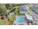 Aerial view of community pool and townhomes near a pond at 2919 Grand Kemerton Pl, Tampa, FL 33618