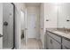 Modern bathroom with a walk-in shower and granite vanity at 2919 Grand Kemerton Pl, Tampa, FL 33618