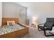 Cozy bedroom with a wooden bed frame and comfortable chair at 2919 Grand Kemerton Pl, Tampa, FL 33618