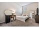 Light and airy bedroom with a queen-sized bed and a vanity area at 2919 Grand Kemerton Pl, Tampa, FL 33618