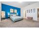 Bright bedroom featuring a teal accent wall and plush carpeting at 2919 Grand Kemerton Pl, Tampa, FL 33618