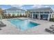Inviting community pool with lounge chairs and covered seating area at 2919 Grand Kemerton Pl, Tampa, FL 33618