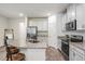 Modern kitchen with white cabinets, granite island, and stainless steel appliances at 2919 Grand Kemerton Pl, Tampa, FL 33618