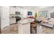 Open concept kitchen and living area with breakfast bar and large sectional sofa at 2919 Grand Kemerton Pl, Tampa, FL 33618