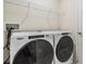Washer and dryer in a convenient laundry room with overhead shelving at 2919 Grand Kemerton Pl, Tampa, FL 33618
