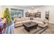 Living room with sectional sofa, coffee table, and access to the backyard at 2919 Grand Kemerton Pl, Tampa, FL 33618