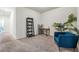 Bright home office featuring a desk, shelving unit, and comfortable armchair at 2919 Grand Kemerton Pl, Tampa, FL 33618