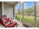 Relaxing screened patio with red chairs overlooking a pond at 2919 Grand Kemerton Pl, Tampa, FL 33618