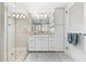 Updated bathroom with walk-in shower and white cabinets at 3400 Gulf Blvd # 105, Belleair Beach, FL 33786