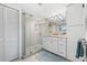 Clean bathroom with a walk-in shower and modern vanity at 3400 Gulf Blvd # 105, Belleair Beach, FL 33786