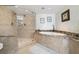 Bathroom with a walk-in shower, soaking tub and granite countertop at 3400 Gulf Blvd # 105, Belleair Beach, FL 33786