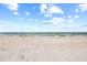 Beautiful, expansive beach with white sand and blue water at 3400 Gulf Blvd # 105, Belleair Beach, FL 33786