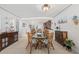 Bright dining area with glass table and wicker chairs, adjacent to kitchen at 3400 Gulf Blvd # 105, Belleair Beach, FL 33786
