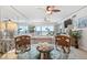 Ocean view dining room with glass table and wicker chairs at 3400 Gulf Blvd # 105, Belleair Beach, FL 33786