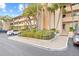 Condo building entrance with landscaping and parking at 3400 Gulf Blvd # 105, Belleair Beach, FL 33786