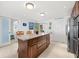 Island kitchen with granite countertops and access to patio at 3400 Gulf Blvd # 105, Belleair Beach, FL 33786