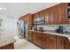 Bright kitchen with granite counters and wood cabinets at 3400 Gulf Blvd # 105, Belleair Beach, FL 33786
