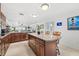 Island kitchen with granite counters, stainless steel appliances, and ocean view at 3400 Gulf Blvd # 105, Belleair Beach, FL 33786