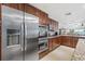 Kitchen with stainless steel appliances and wood cabinets at 3400 Gulf Blvd # 105, Belleair Beach, FL 33786