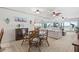 Open living room with ocean view, featuring white couch and glass coffee table at 3400 Gulf Blvd # 105, Belleair Beach, FL 33786