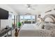 King-size bed in main bedroom with ocean view and private balcony access at 3400 Gulf Blvd # 105, Belleair Beach, FL 33786