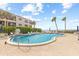 Inviting kidney-shaped pool with lounge chairs; oceanfront at 3400 Gulf Blvd # 105, Belleair Beach, FL 33786